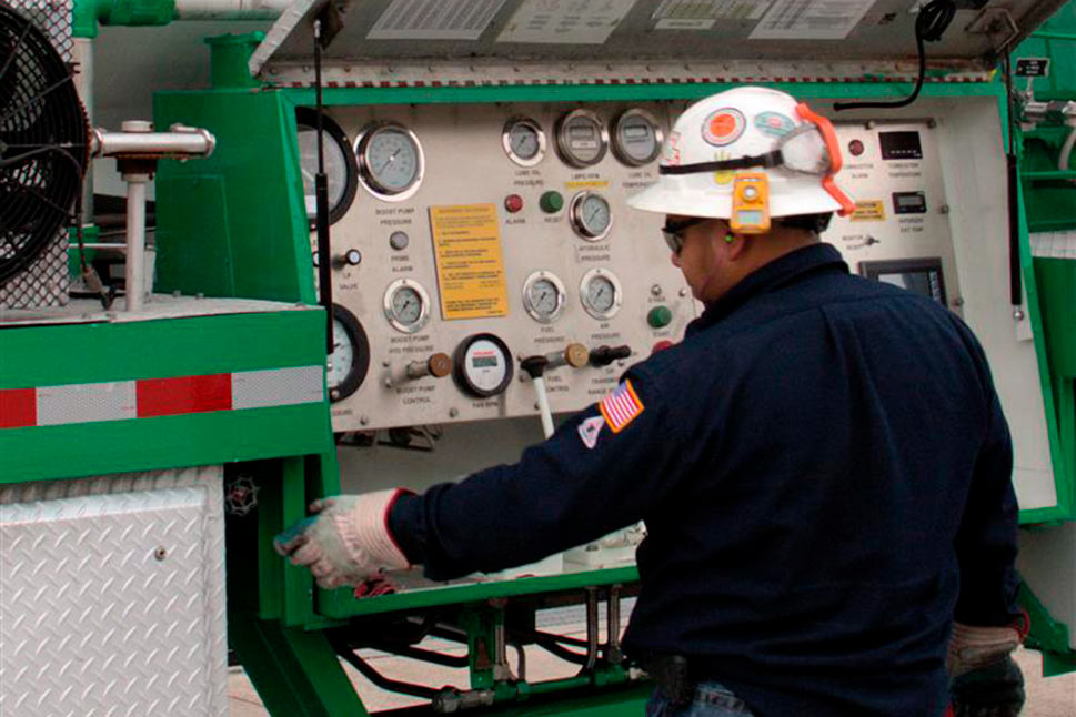 Air Products Express Services technician working at control panel on nitrogen pumper.