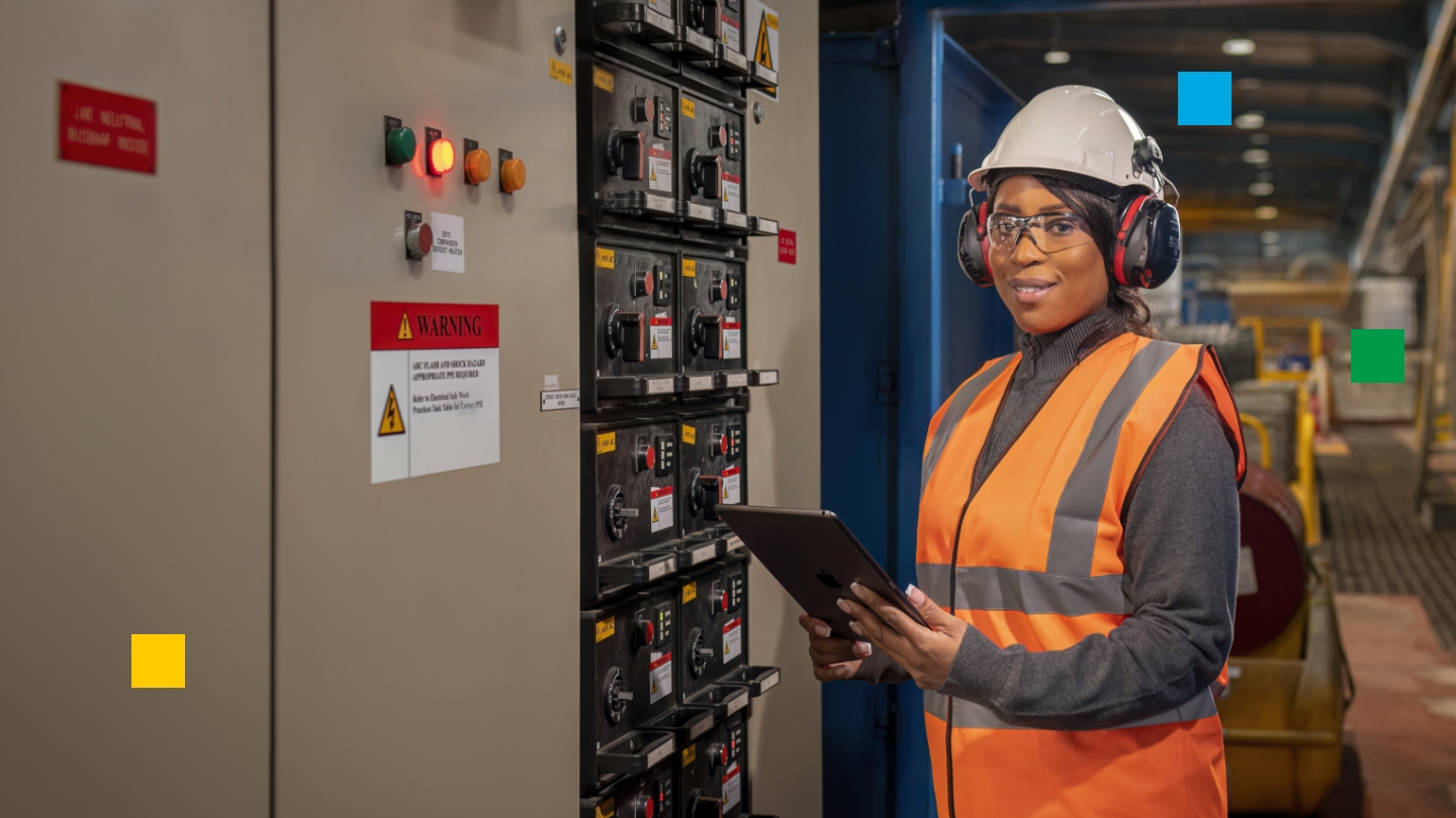 Female plant technician wearing hard hat and other PPE (personal protective equipment)