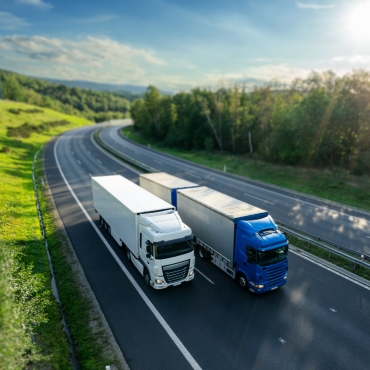 Two tractor trailers on scenic highway